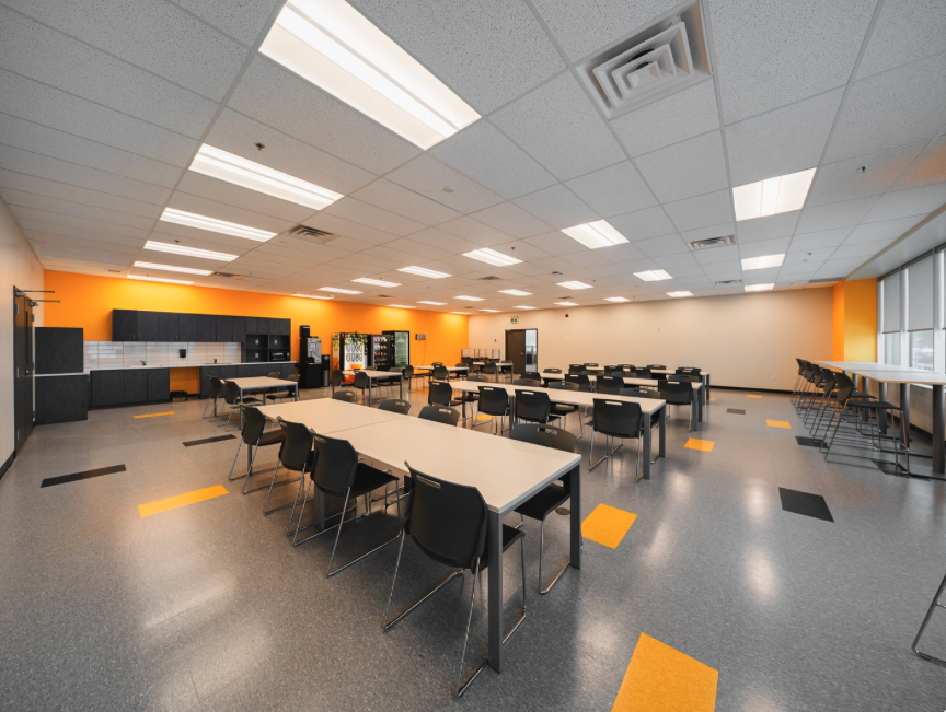Bright open workspace with an orange feature wall in a finished commercial building