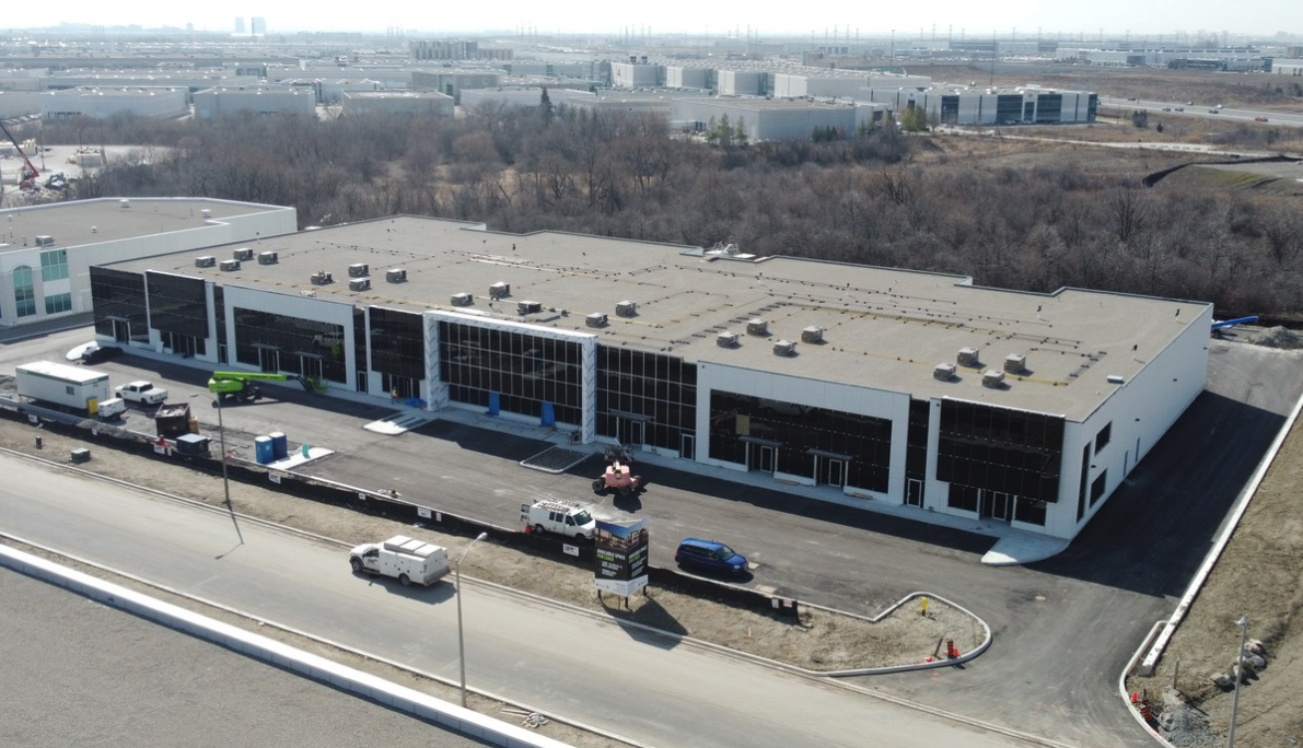 Industrial building with trucks and equipment on site