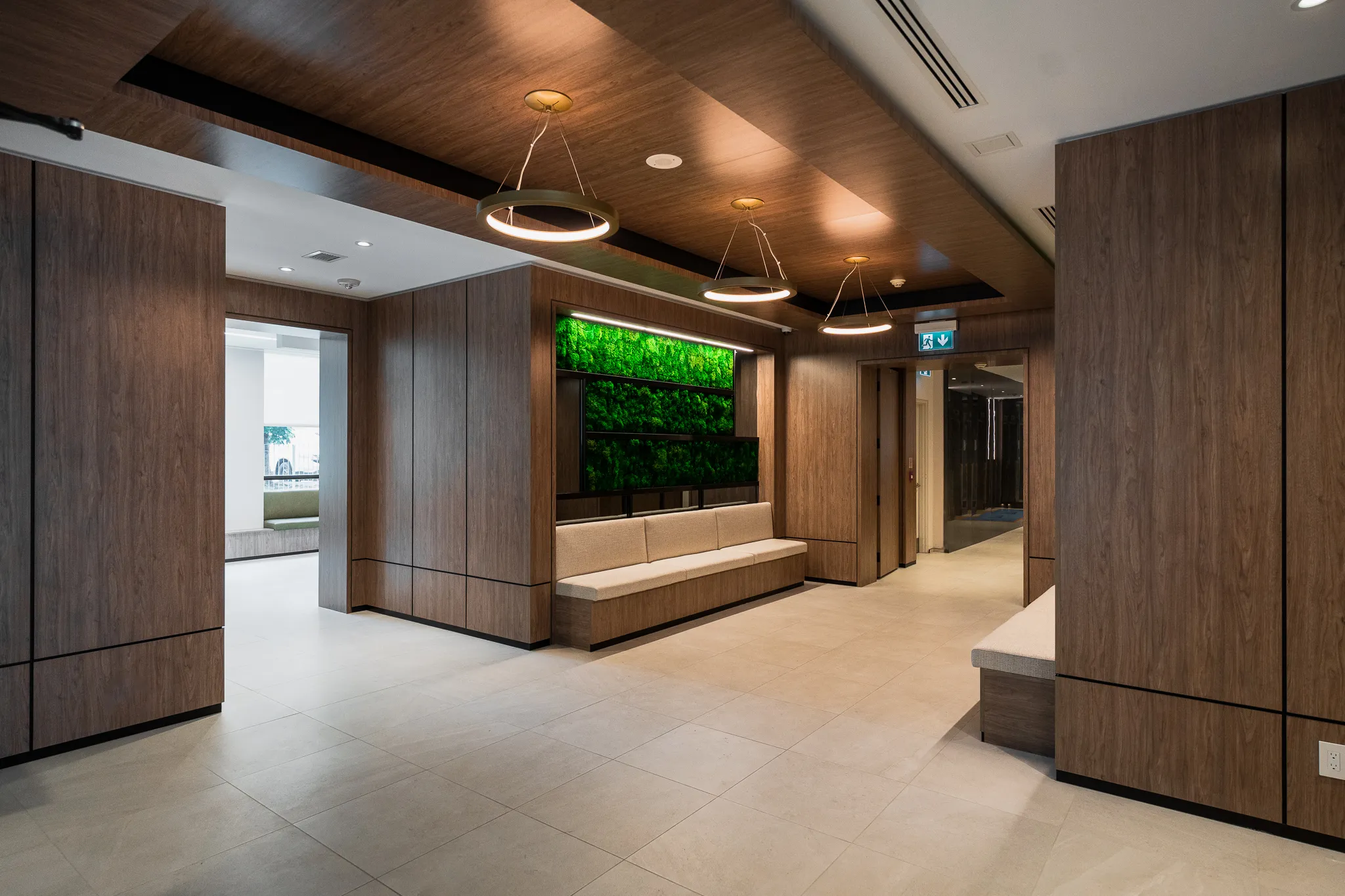 Multi-residential lobby with wood panels and a living wall