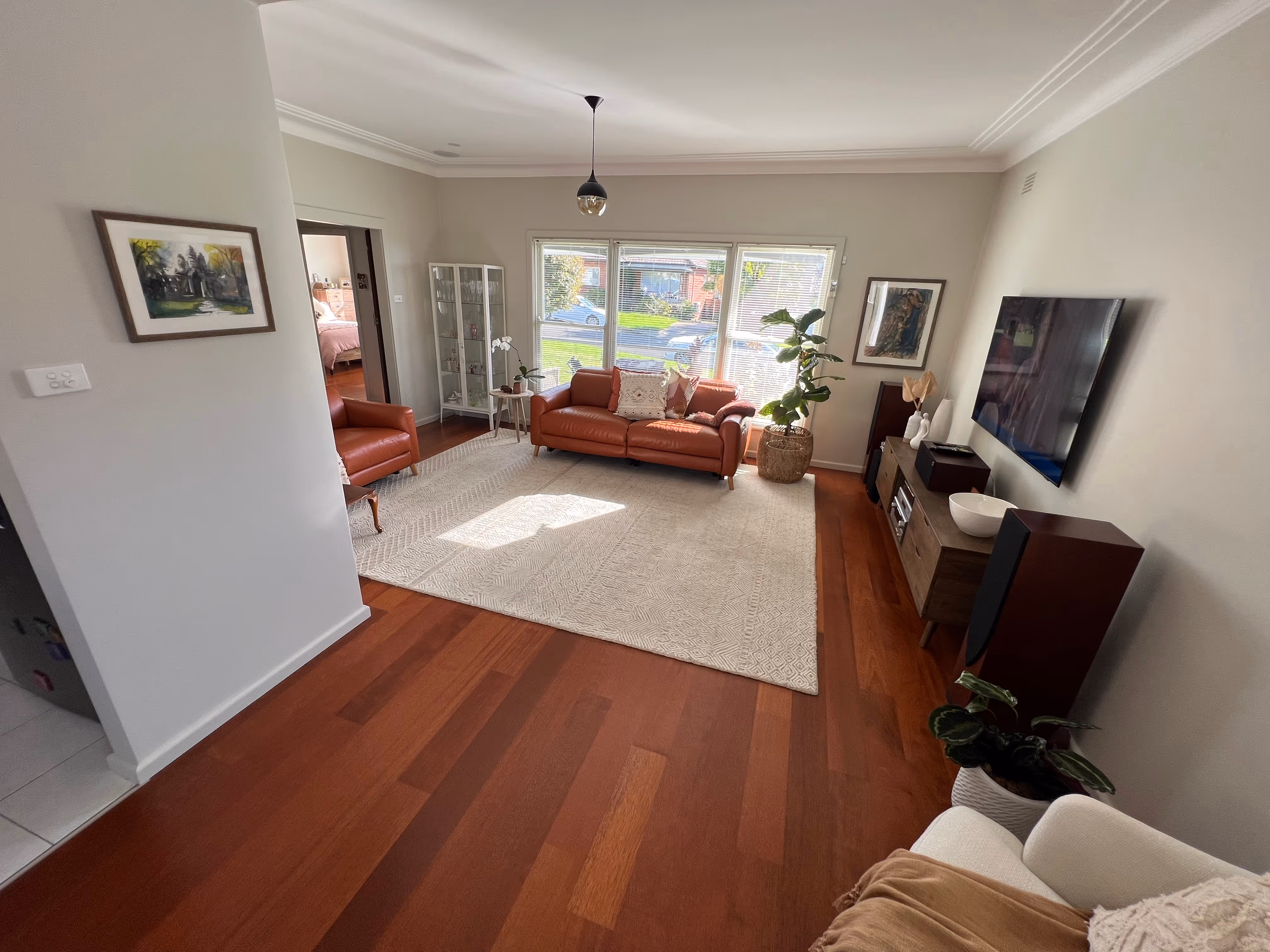 Interior featuring gumtree engineered timber flooring with warm, reddish-brown hues and distinctive grain patterns.