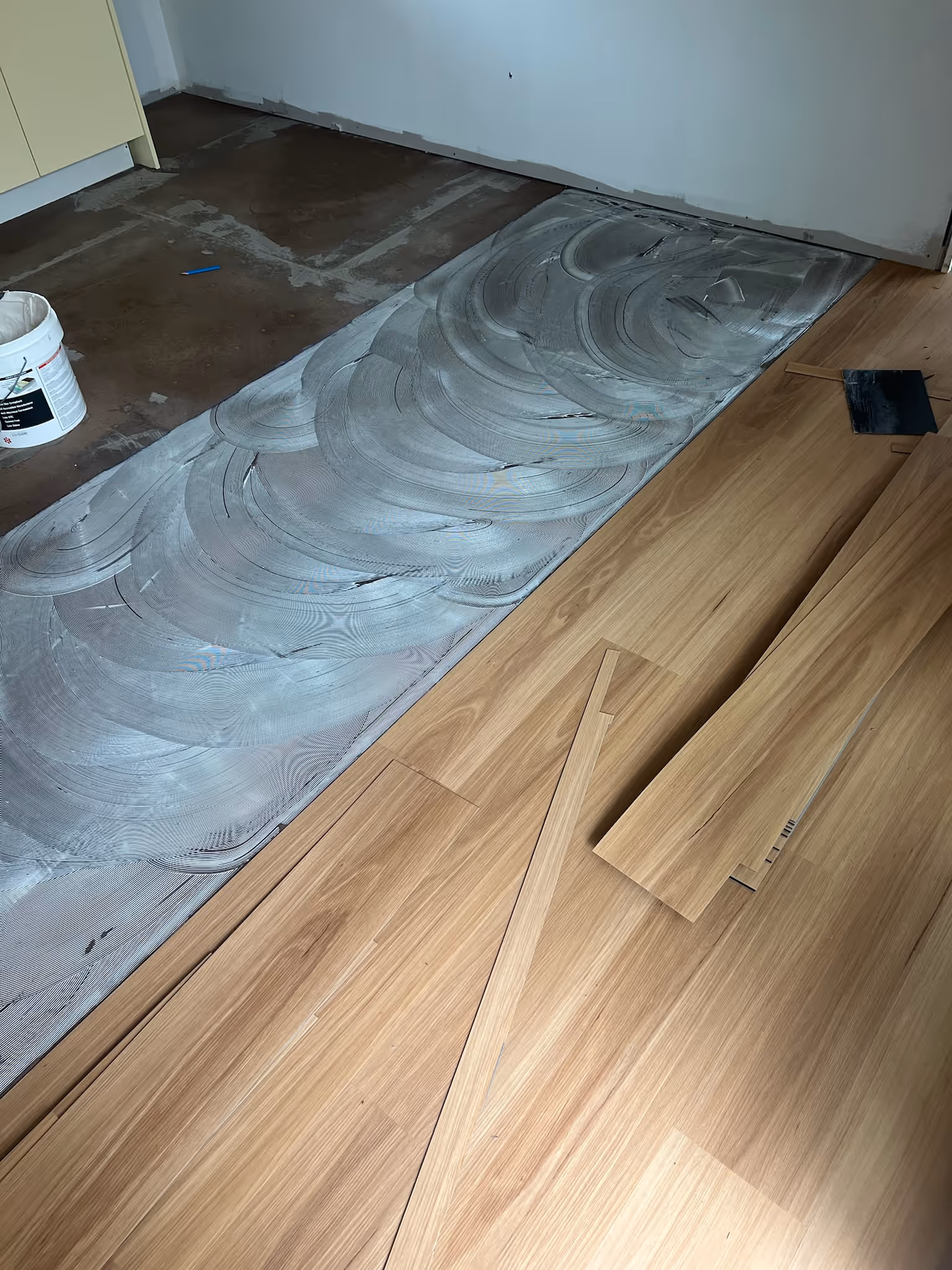 Step-by-step vinyl plank flooring installation, showing planks being aligned, clicked into place, and secured.