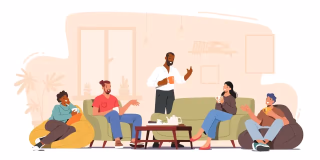 Five diverse people chatting and drinking coffee while sitting on sofas and bean bags in a cozy living room.