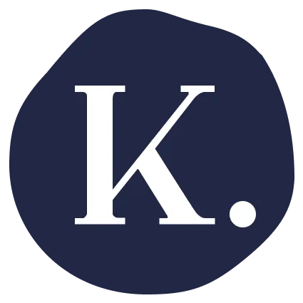 White letter K with a period on a dark blue circular background.