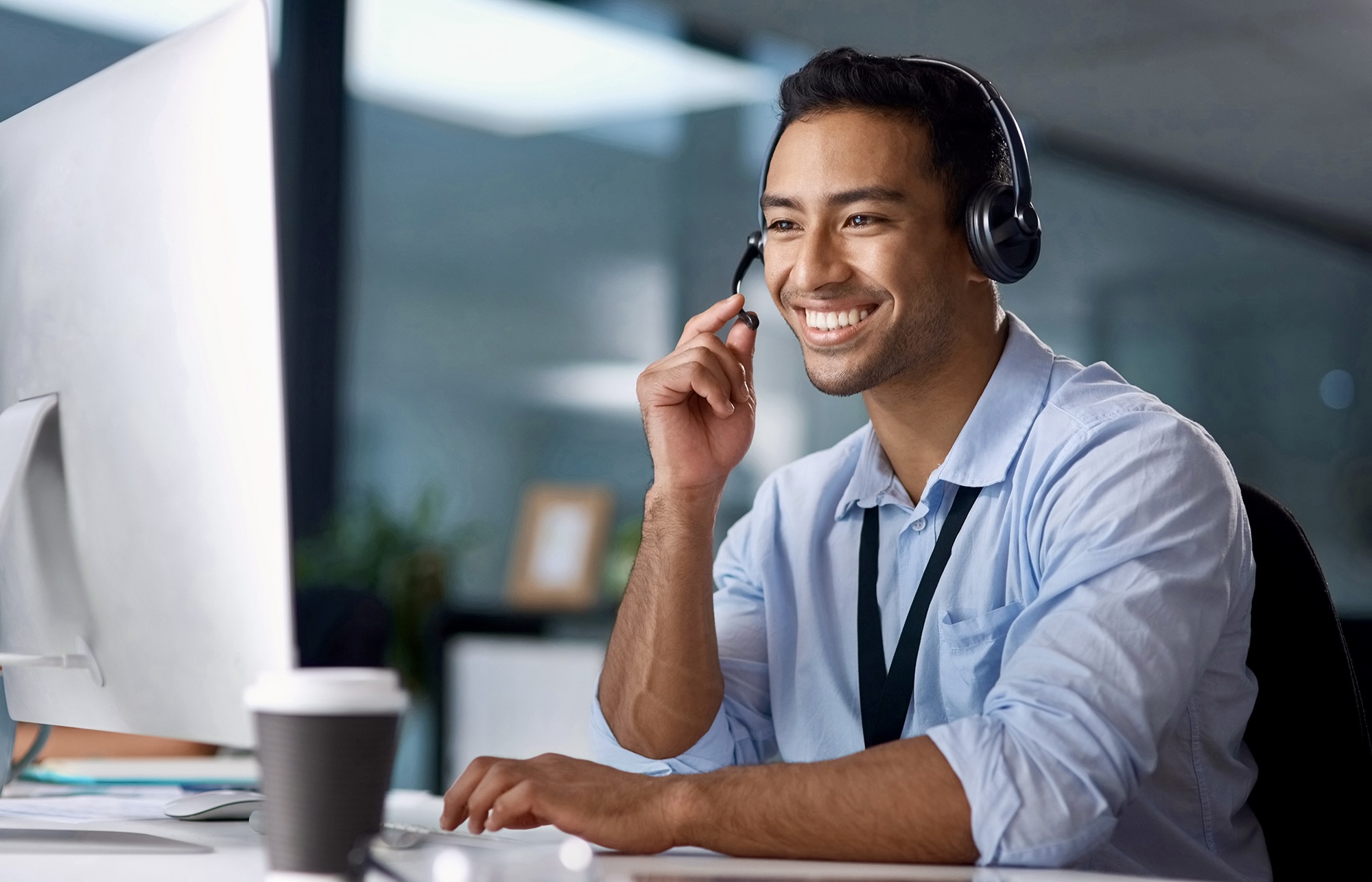 profesional working on his comptuter and smiling
