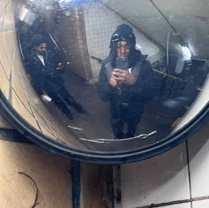 Picture of artist in curved stairwell mirror 