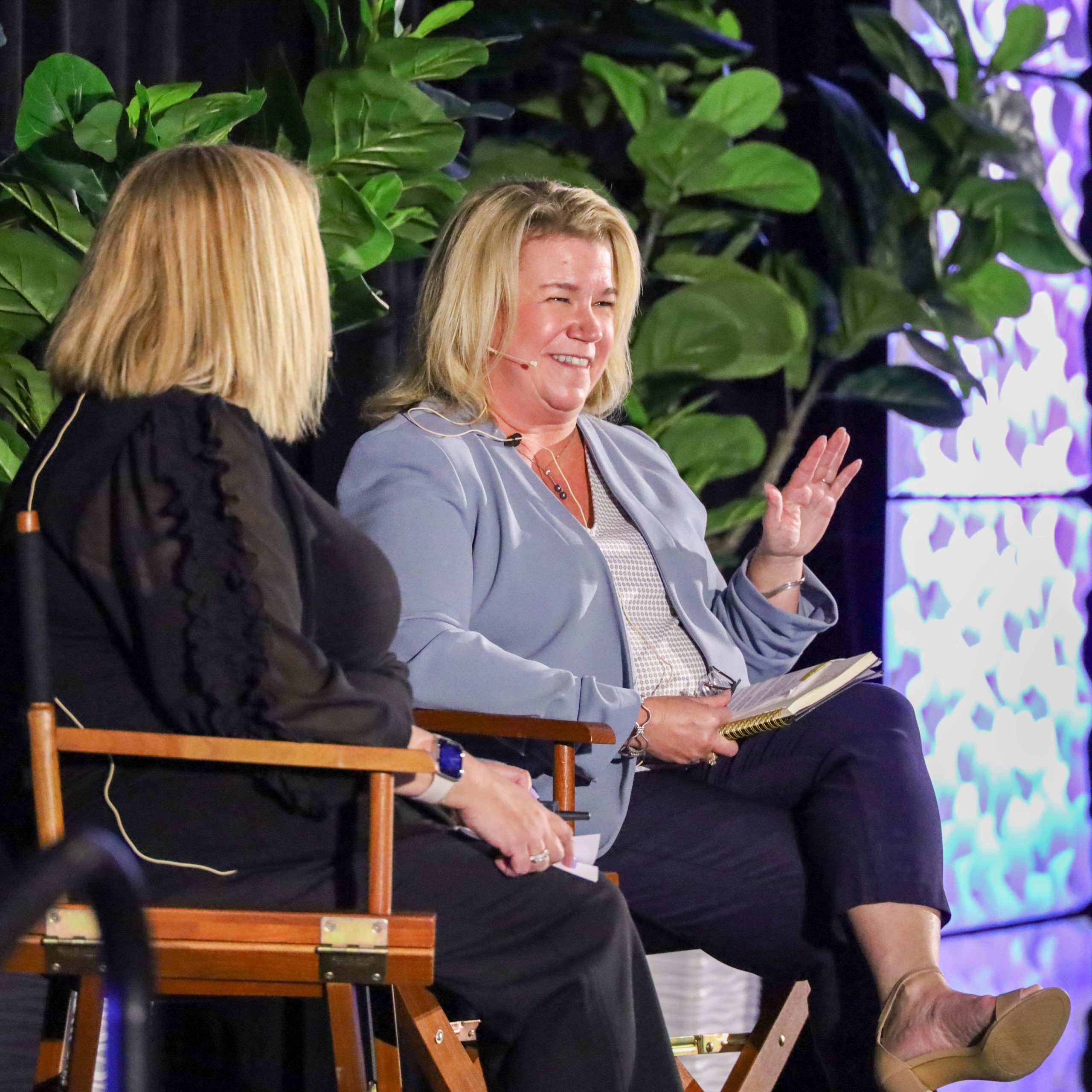 Two speakers in conversation on stage at an IPMI Institute