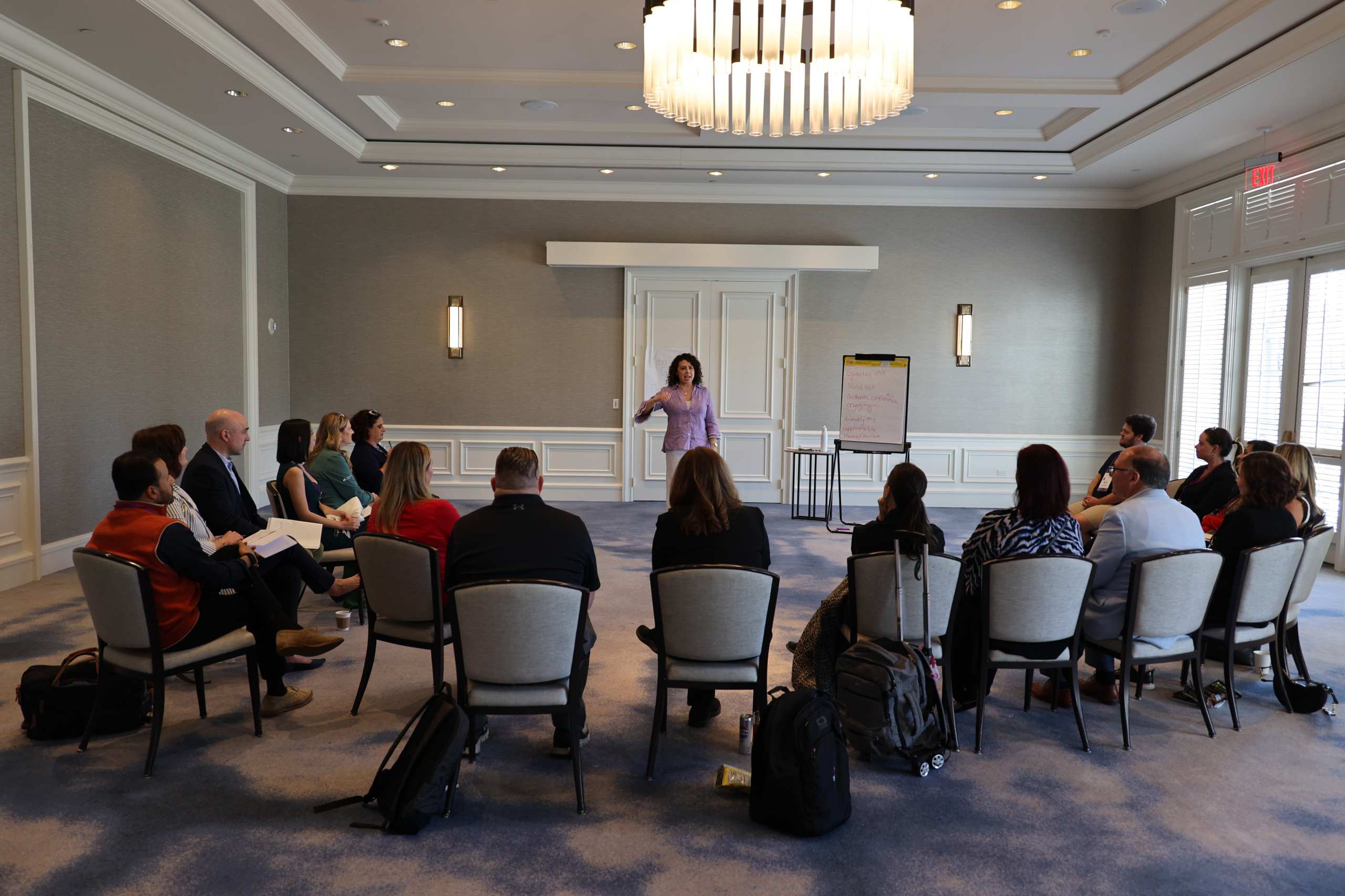A facilitator leading a Think Tank discussion with participants seated in a circle