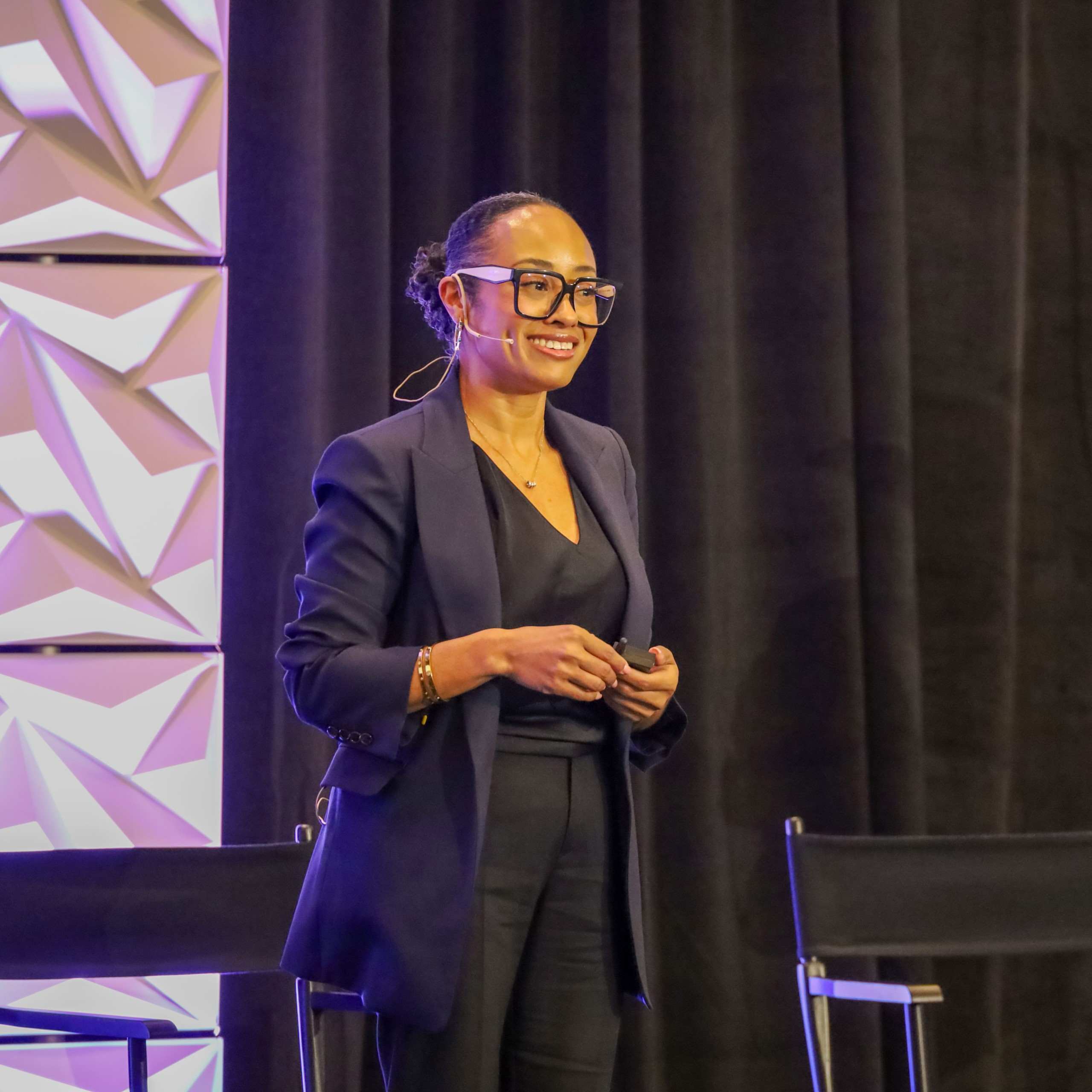 A speaker presenting on stage at an IPMI Institute