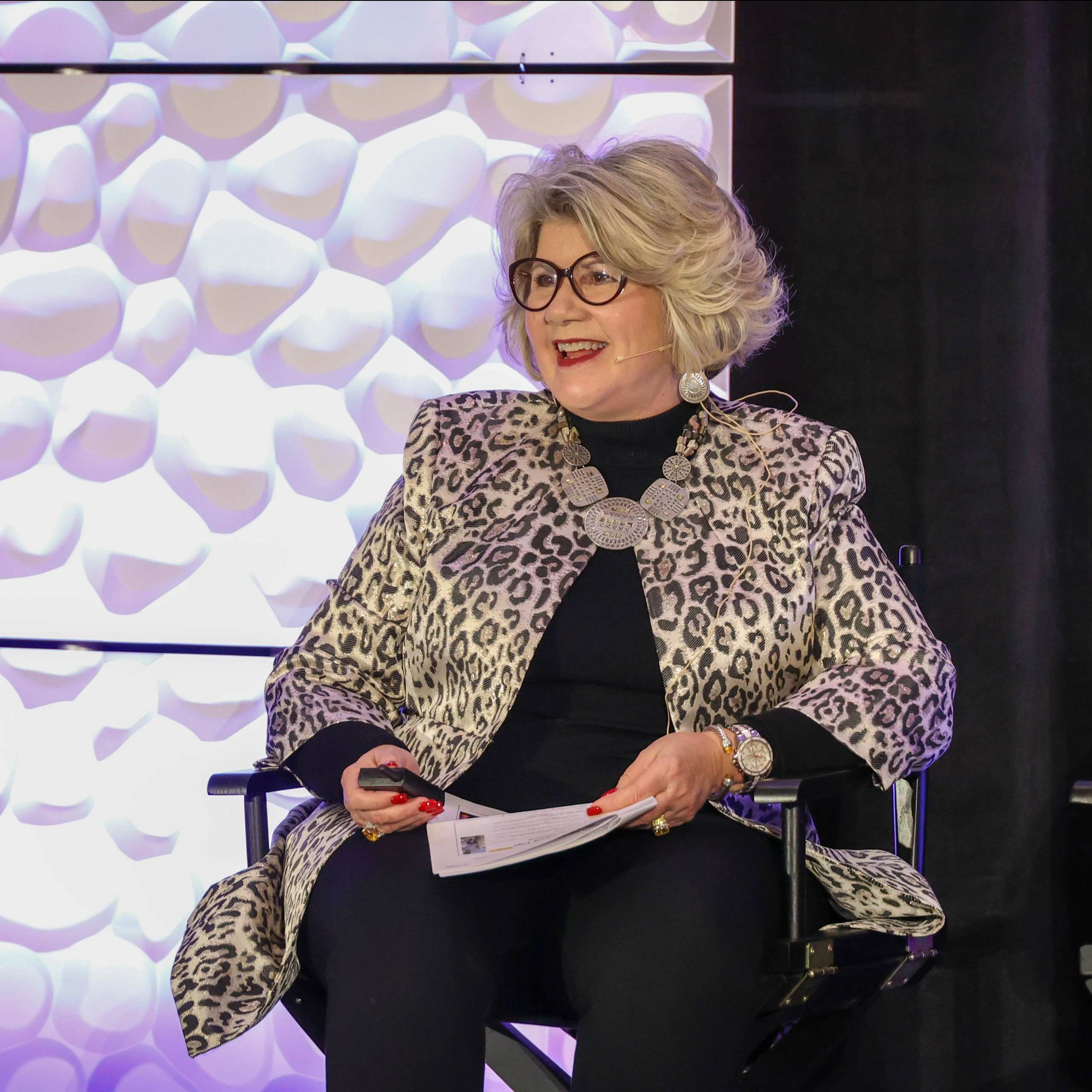 A speaker seated on stage during an IPMI Institute session