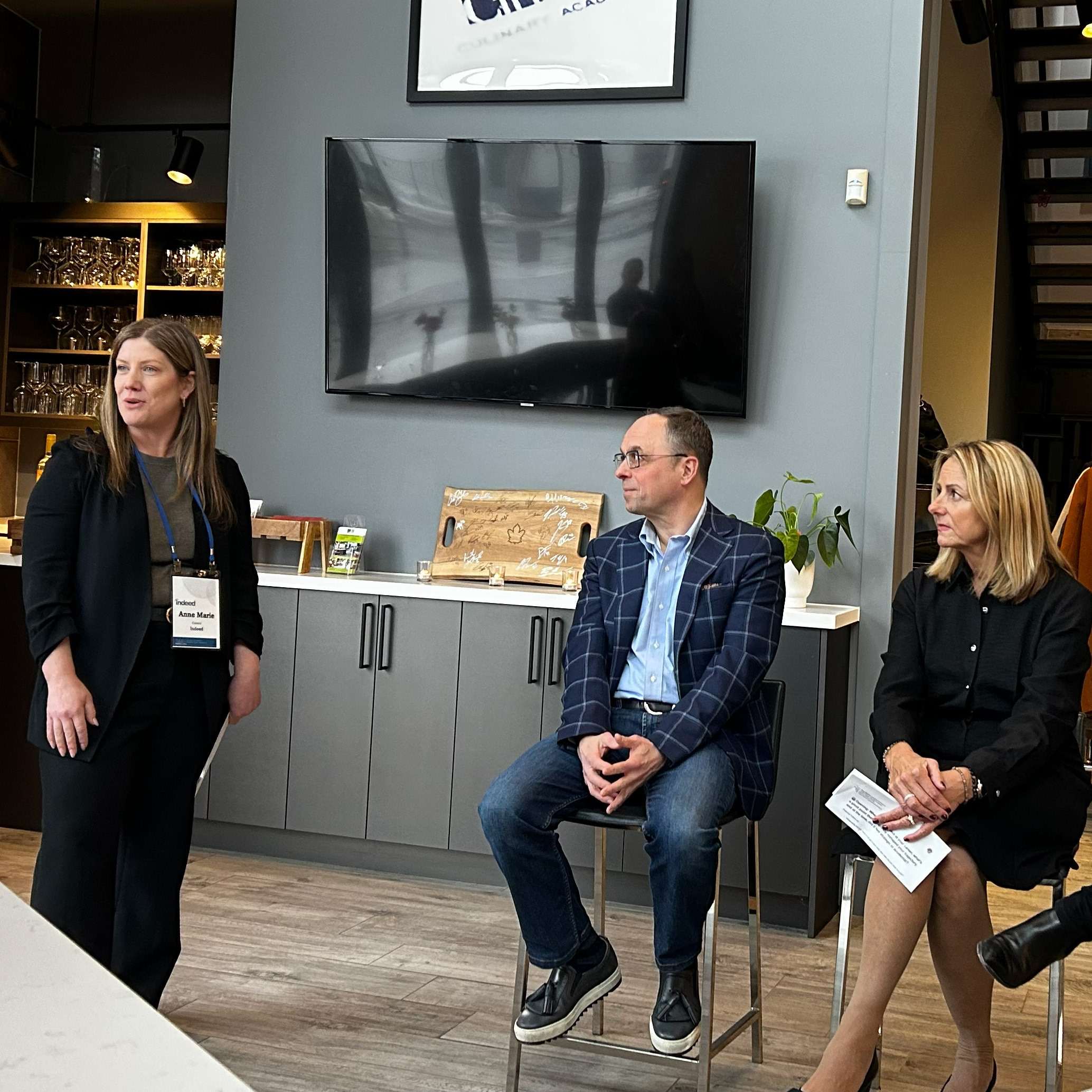 A participant speaking to seated colleagues during an IPMI roundtable