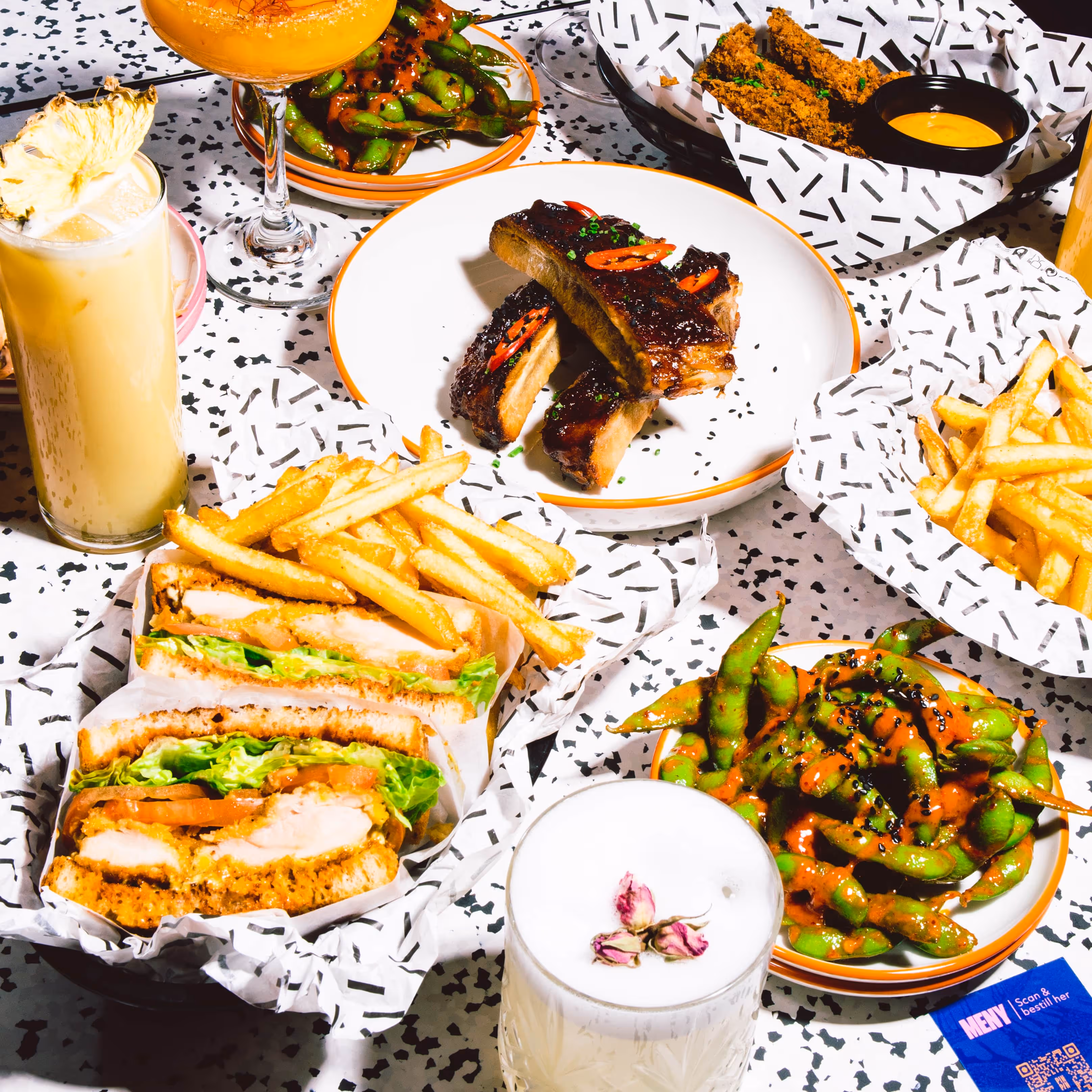 Example of different plates served at the restaurant at PINPIN. Includes burges, steakes, fries and drinks