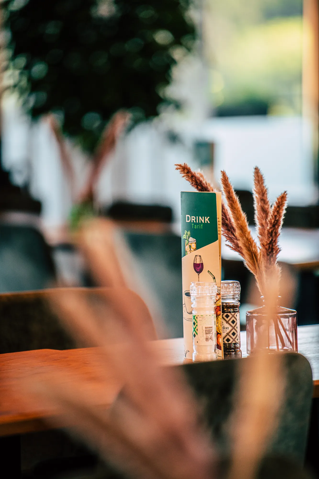 Tafels en stoelen onder een groot doek op het buitenterras