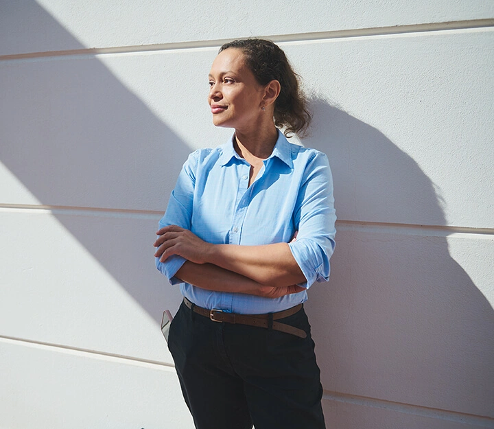 An image of a confident woman in work attire