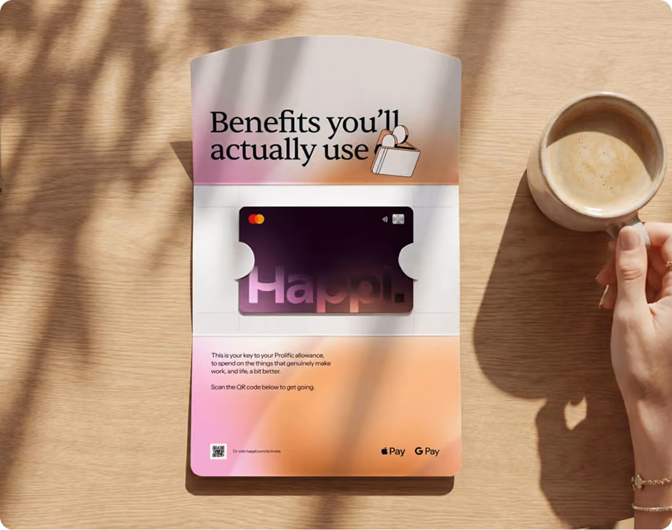 A hand holding a cup of coffee next to a wooden table with a cardholder displaying a Happl card and text reading 'Benefits you’ll actually use' and instructions to scan a QR code to activate the card with Apple Pay and Google Pay logos at the bottom.