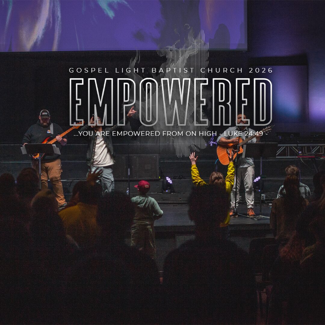 The worship band with the worship leader praising God with his hands raised.