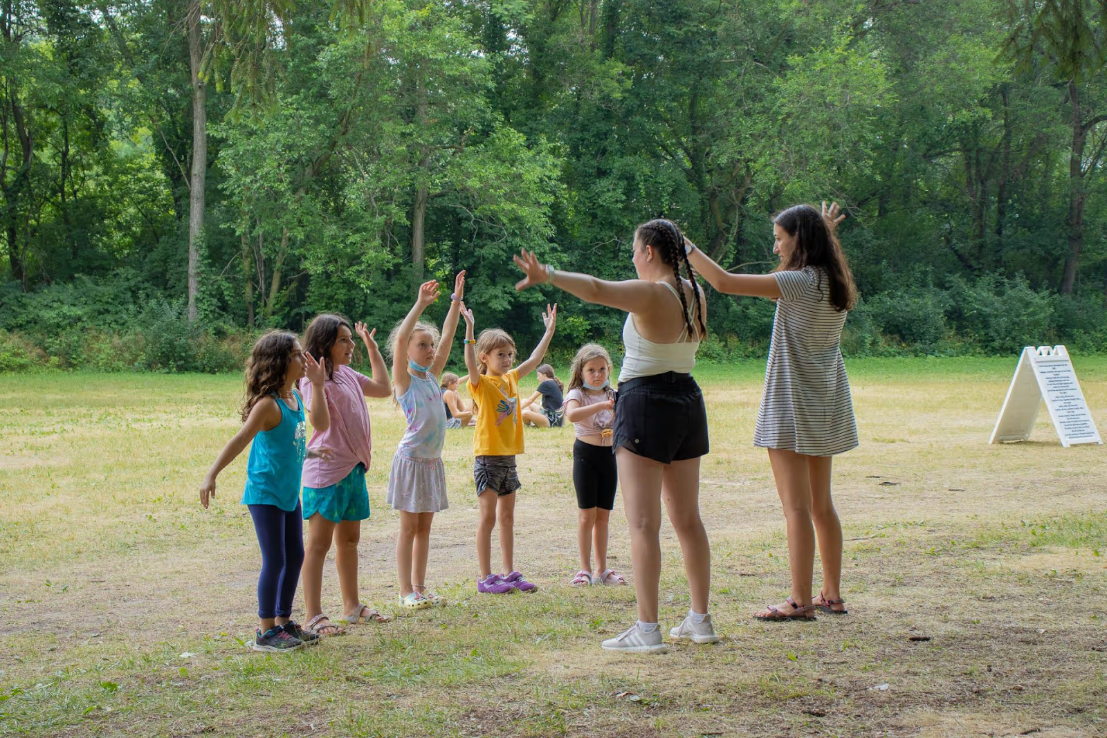 Los monitores del campamento y los participantes en un juego al aire libre en el Campamento Beber