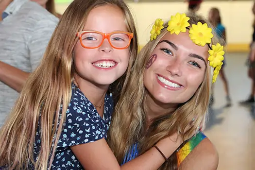 A camp counsellor and camper posing for a photo at Camp Nock-A-Mixon