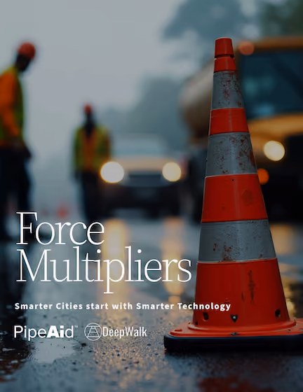Close-up of an orange and gray traffic cone on a wet road with blurred workers and vehicles in the background, overlaid with text 'Force Multipliers Smarter Cities start with Smarter Technology' and logos for PipeAid and DeepWalk.