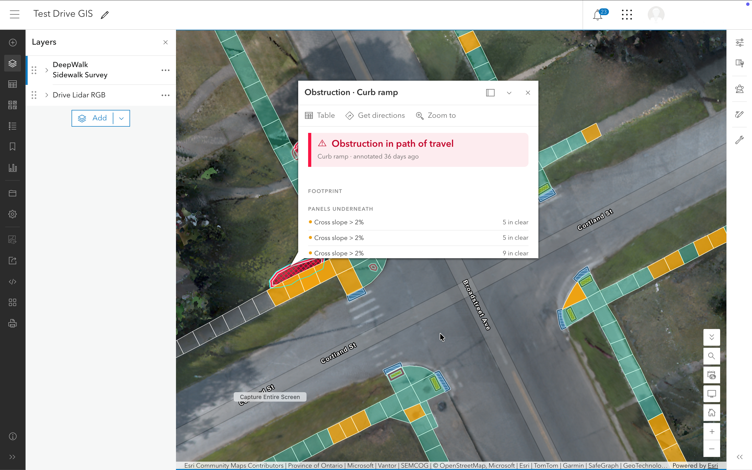 Screenshot of a GIS map interface titled Test Drive GIS showing mapped curb ramps and sidewalks at an intersection with colored segments indicating survey data; a popup highlights an 'Obstruction in path of travel' on a curb ramp with details on cross slope panels underneath.