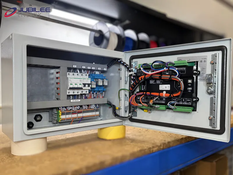 Open control enclosure on the workshop bench showing the internal wiring