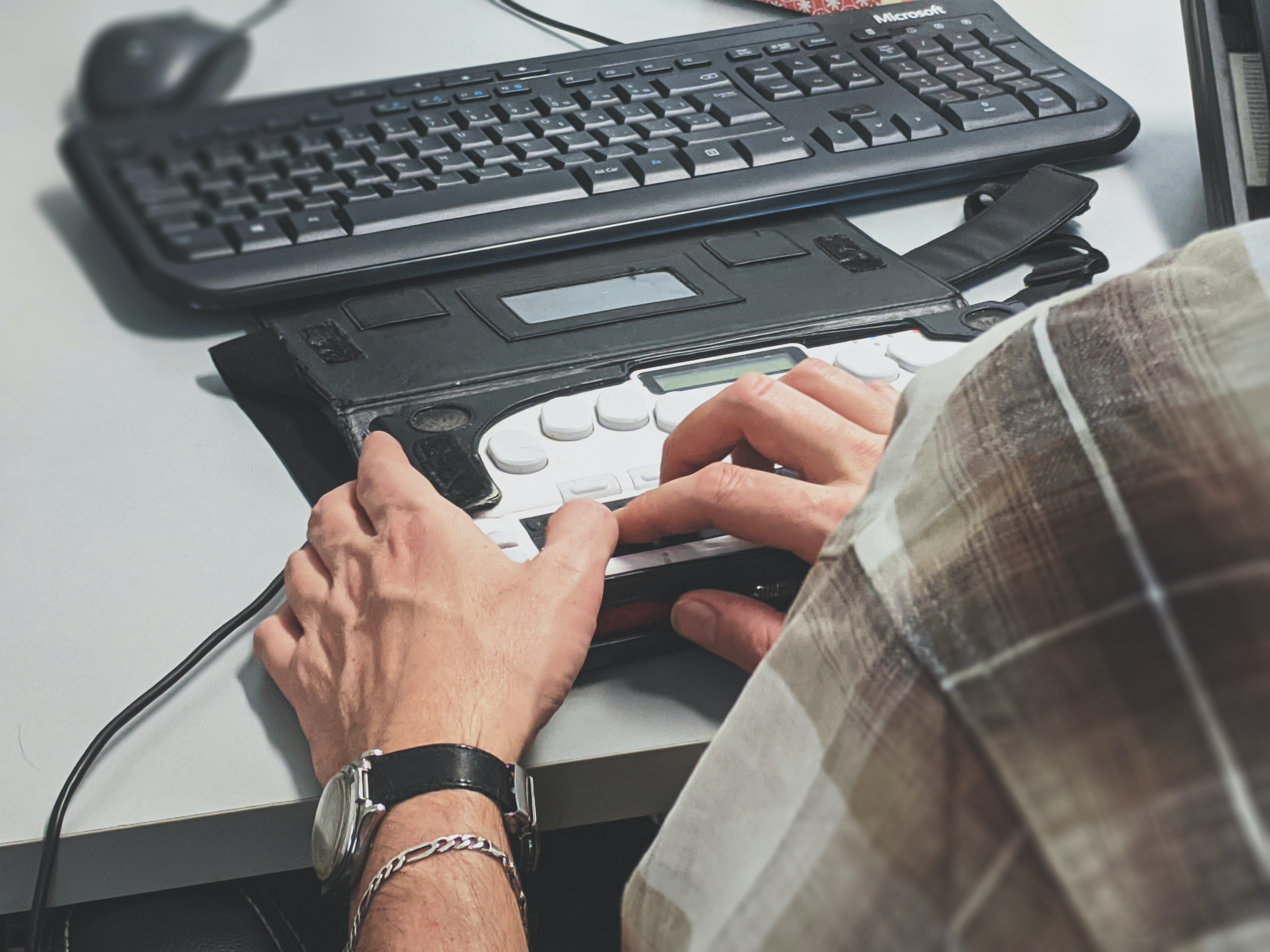 A Man Is Working on a Computer with a Keyboard