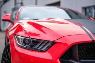 close up front view of a red mustang