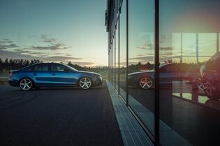 car parked in front of a glass building