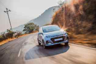 front view of a hyundai driving on a rural road