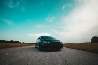 car on the road with the blue sky in the background