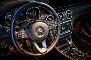 close up of a mercedes steering wheel and center console