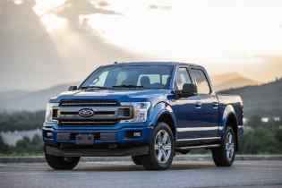 view of the front and side of a blue ford pick up truck