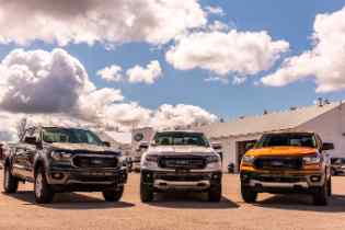 front view of three ford trucks