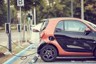 small car at an electric charging station