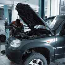 side view of the front half of a vehicle with the hood up