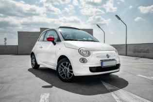 white fiat 500 in a parking lot