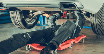 Luxury car on hydraulic lift in auto repair shop