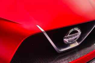 close up of the front of a red nissan