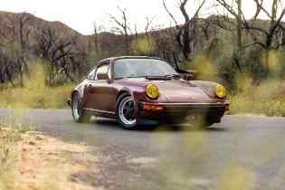 porsche on a rural road with trees in the background