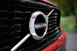 close up of the volvo badge on a red car