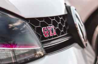 close up of a vw gti headlamp and grill