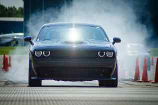 front view of a car with steam in the background