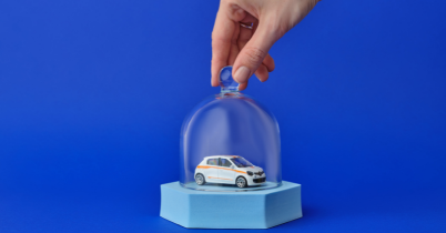 people at a dealership signing for a car