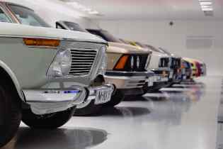side view of the front a old cars lined up in a show room