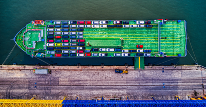 Aerial view of a crowded car lot filled with new vehicles.