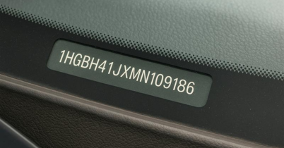 A man is looking for his VIN (Vehicle Identification Number) on his car.