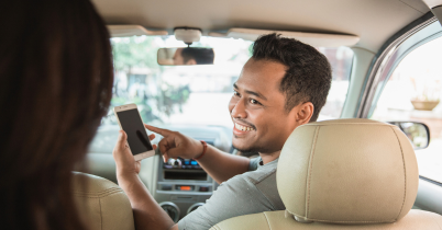 Rideshare driver transporting a passenger, illustrating the need for high-mileage vehicle protection.