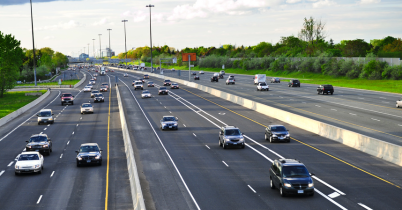 Driver commuting to work in morning traffic, showing daily mileage and wear that makes commuter warranty coverage important.