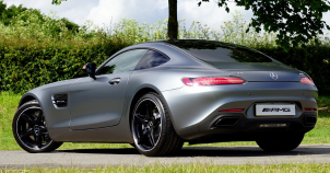 Luxury car owner driving a premium vehicle, representing long-term ownership costs and planning with a luxury car warranty.