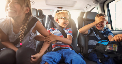 Driver adjusting dashboard controls while diagnosing car noises and what they mean