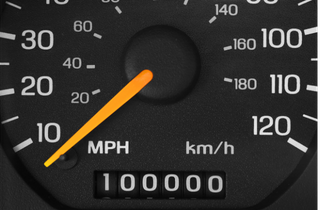 Car odometer approaching 100,000 miles, highlighting the point where out-of-warranty car repair costs and 100k car maintenance begin to increase